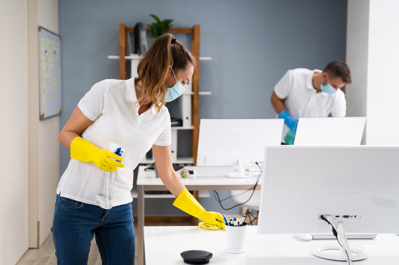 Men and women cleaning office room