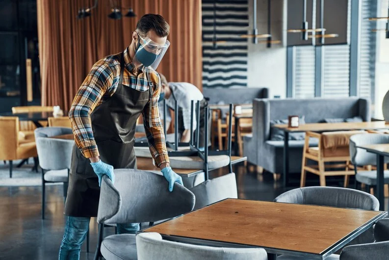 Expert Cleaner Cleaning Furniture of Restaurant