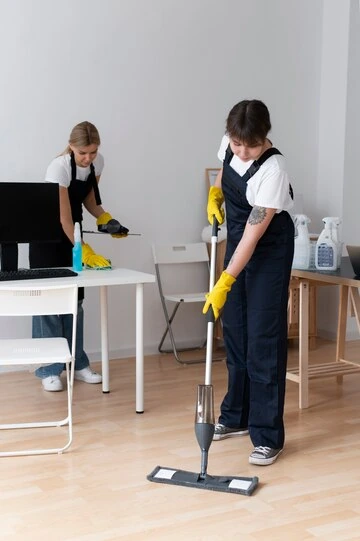 Cleaners Cleaning Floor of Restaurant