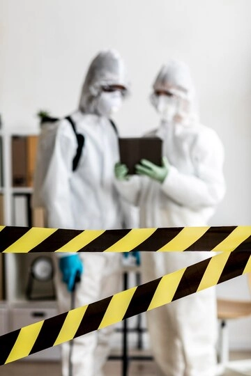 biohazard cleaning professionals in protective suite